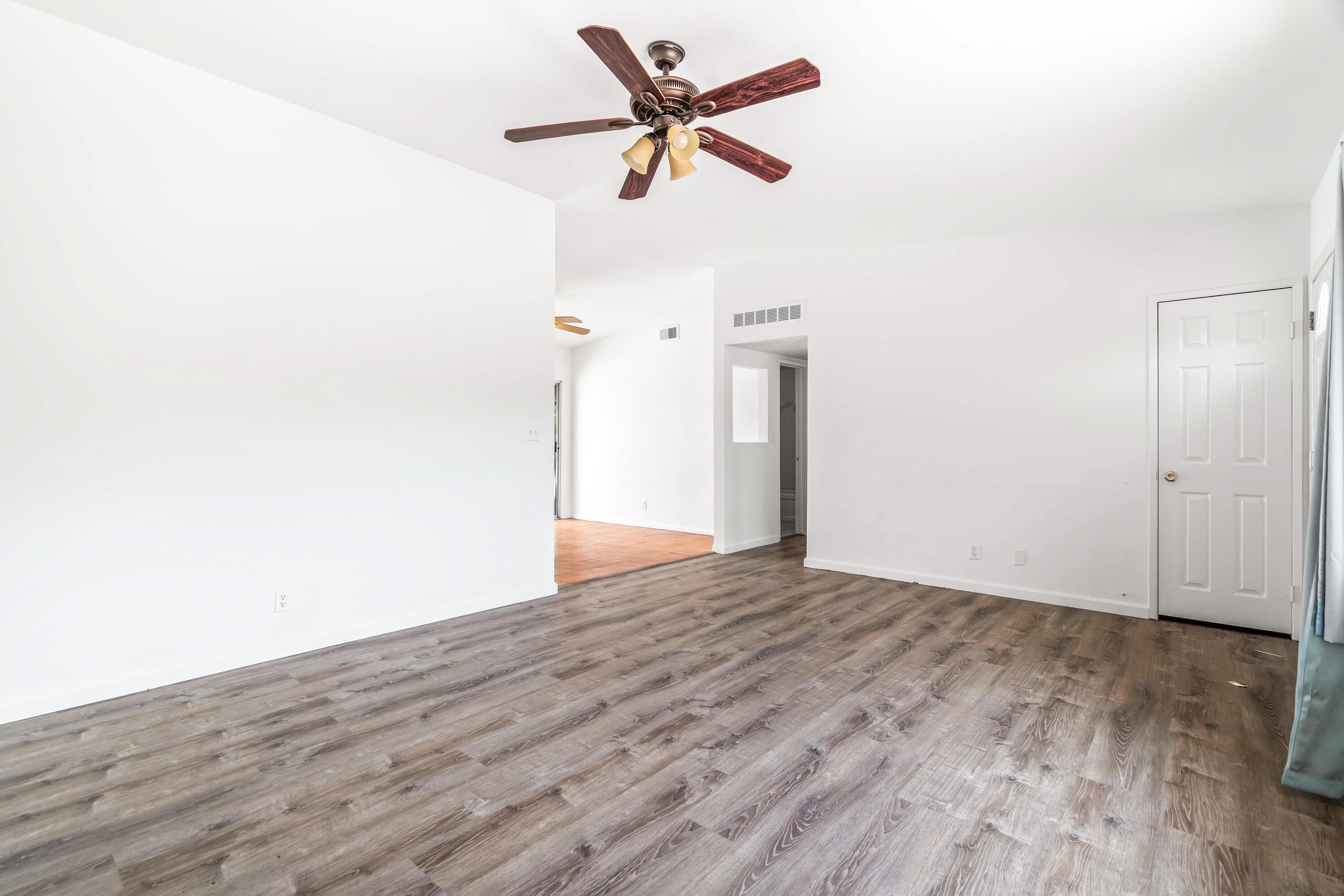 43831 Joshua Road Palm Desert, CA 92260 - Photo 5 of 42 a view of a livingroom with wooden floor and a ceiling fan