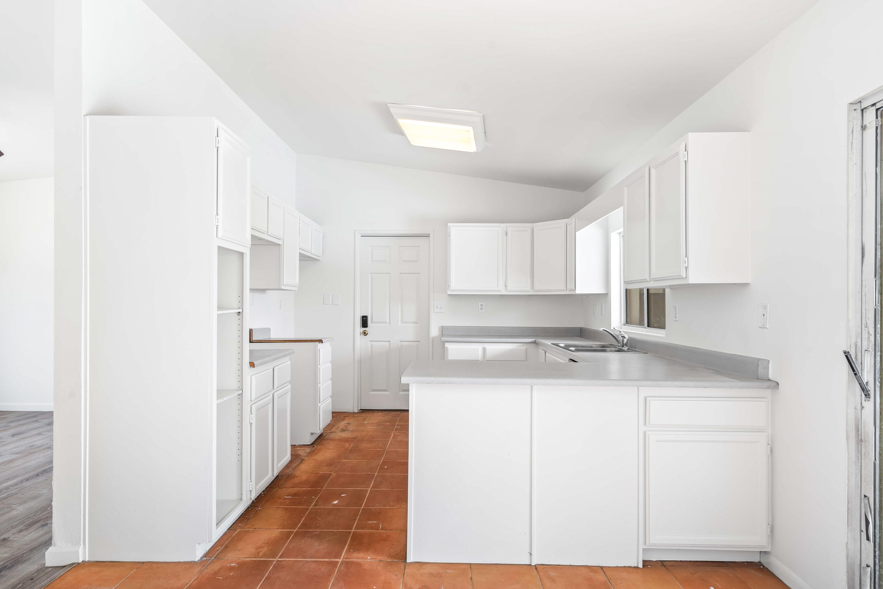 43831 Joshua Road Palm Desert, CA 92260 - Photo 8 of 42 a kitchen with a sink a stove a refrigerator and cabinets