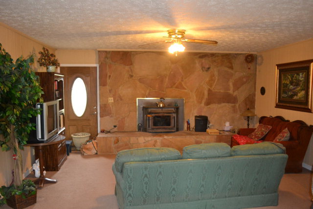 1949 Bonner Gilbert Road Macon, GA 31220 - Photo 4 of 15 a living room with furniture a mirror and a fireplace