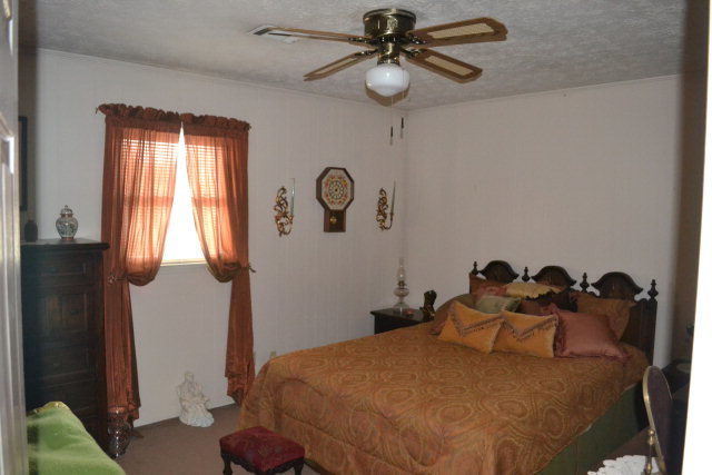 1949 Bonner Gilbert Road Macon, GA 31220 - Photo 9 of 15 a bedroom with a bed and a chandelier