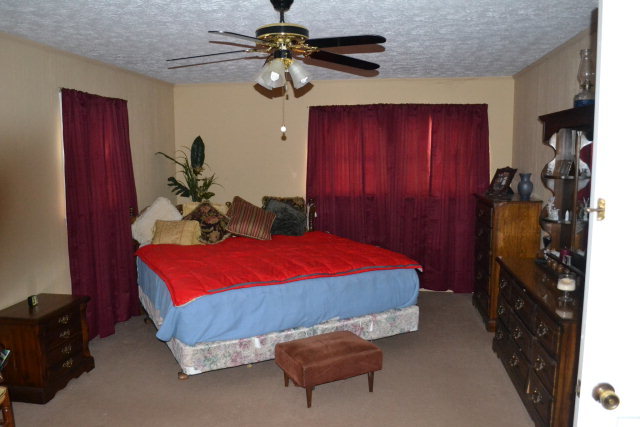 1949 Bonner Gilbert Road Macon, GA 31220 - Photo 10 of 15 a bedroom with a bed and a chandelier