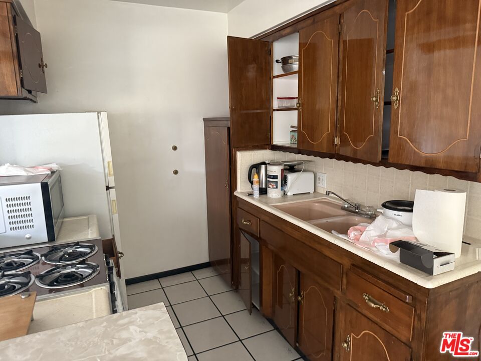 904 North 1st Street Alhambra, CA 91801 - Photo 13 of 17 a kitchen with a sink and a stove top oven