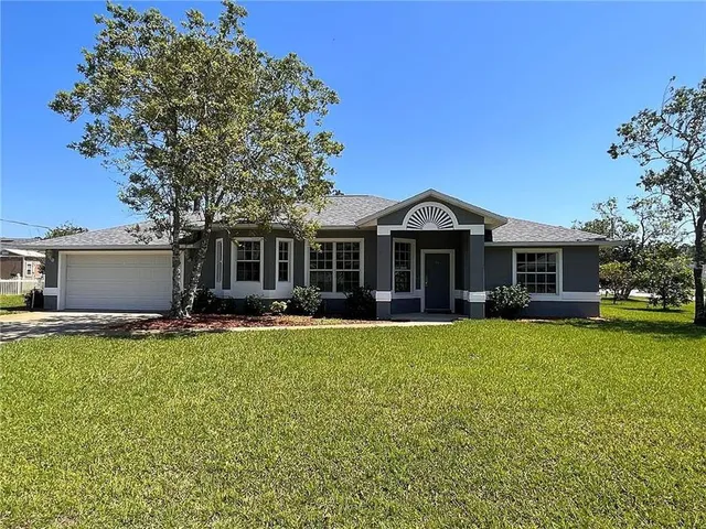 a front view of a house with a garden and porch