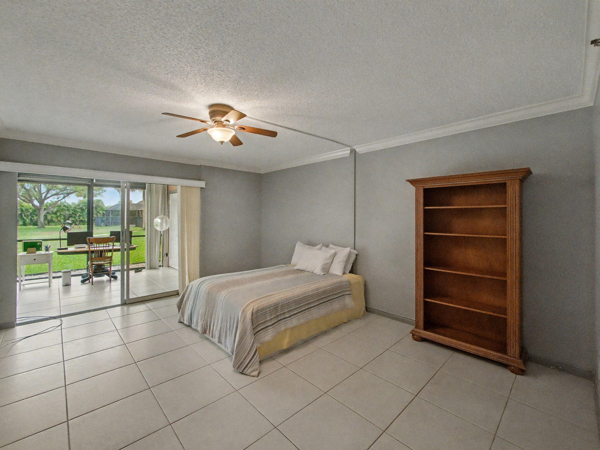 9220 Southwest 14th Street, Unit 3103 Boca Raton, FL 33428 - Photo 15 of 27 a spacious bedroom with a bed and a lamp with window
