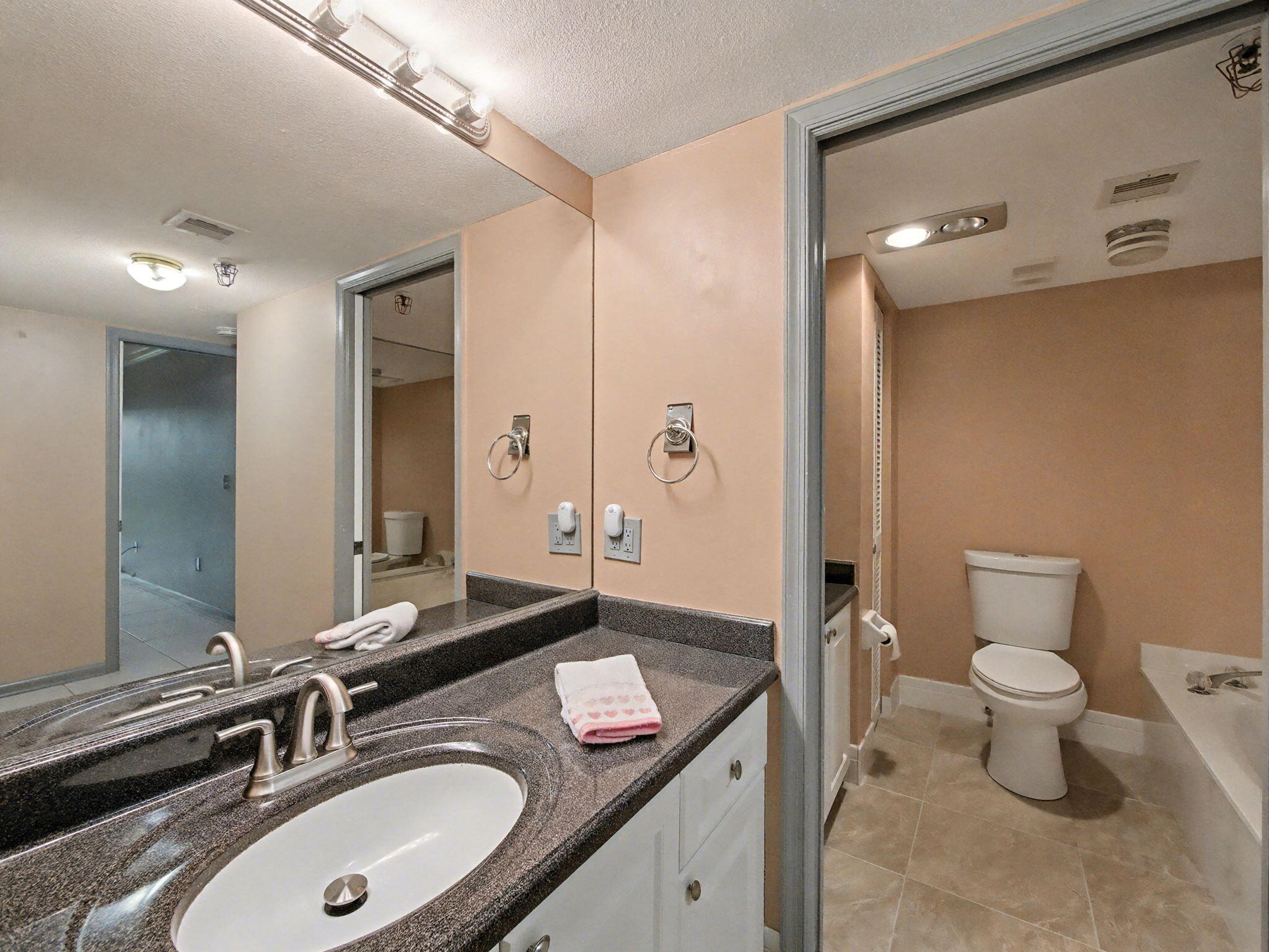 9220 Southwest 14th Street, Unit 3103 Boca Raton, FL 33428 - Photo 16 of 27 a bathroom with a granite countertop sink and a mirror
