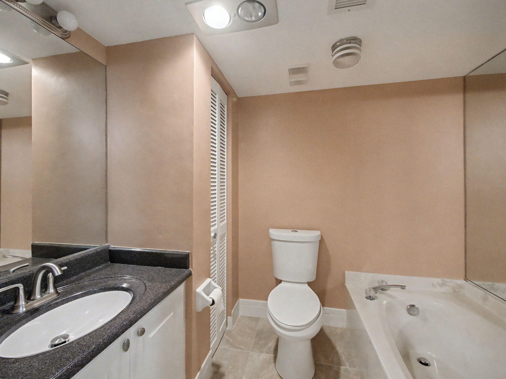 9220 Southwest 14th Street, Unit 3103 Boca Raton, FL 33428 - Photo 18 of 27 a bathroom with a sink toilet and shower