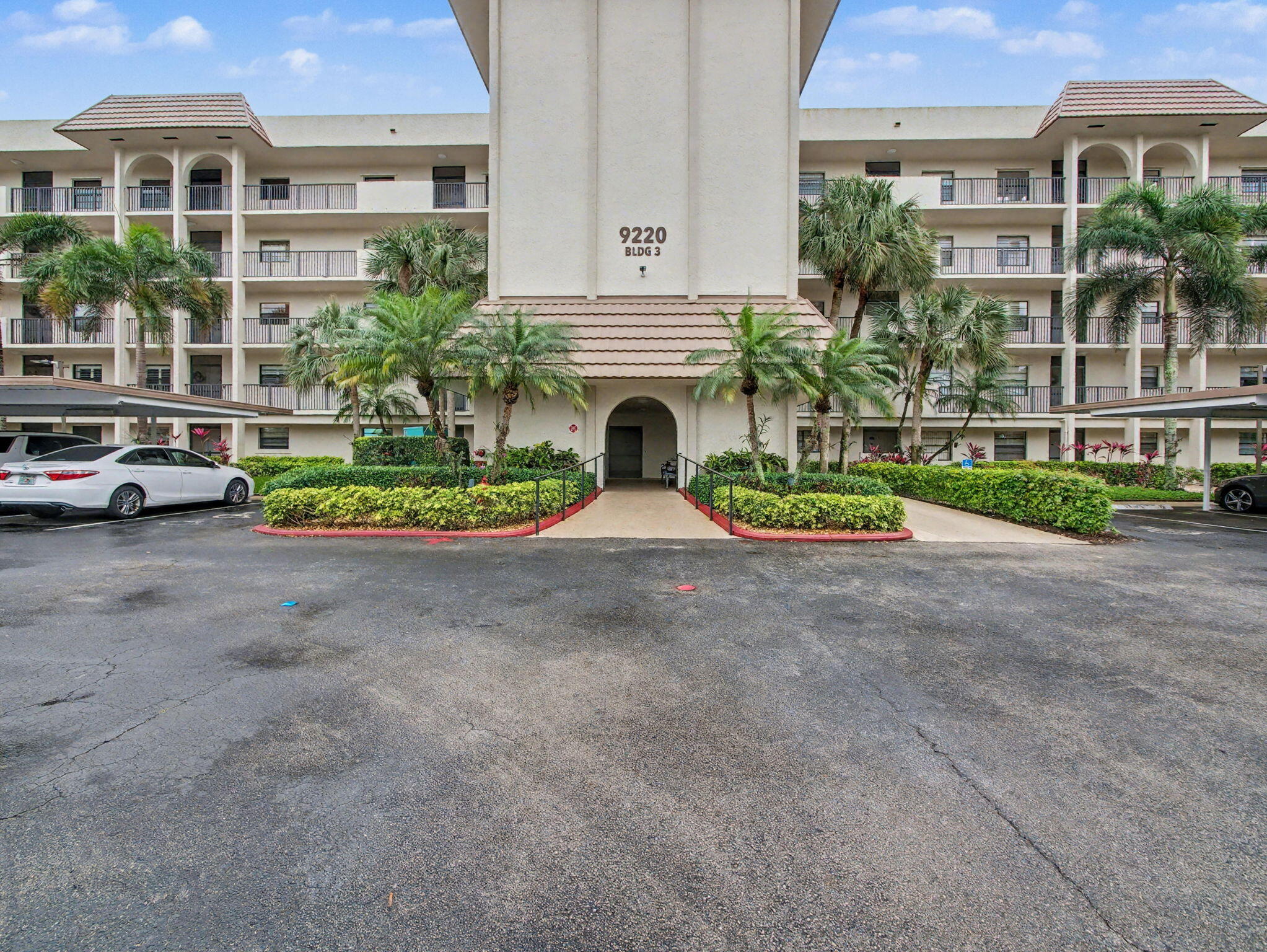 9220 Southwest 14th Street, Unit 3103 Boca Raton, FL 33428 - Photo 2 of 27 a front view of a house with a garden and plants