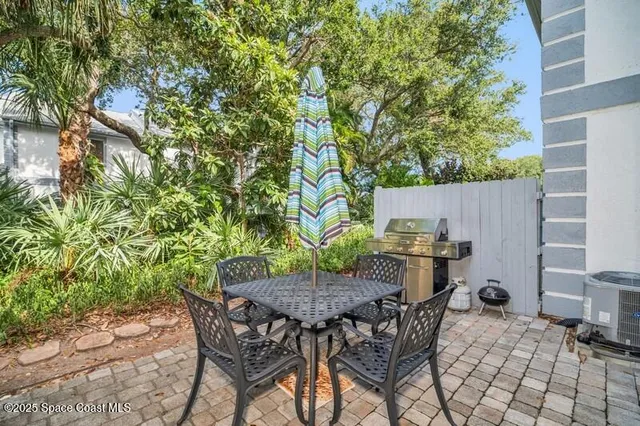 a view of a backyard with table and chairs and potted plants