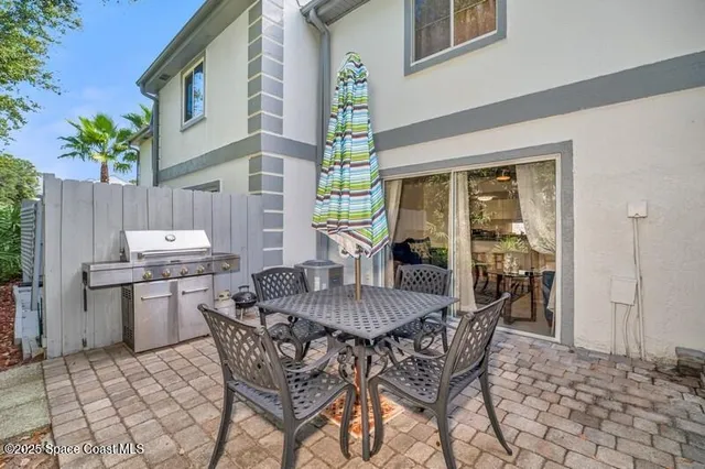 a view of a dining table and chairs in the patio