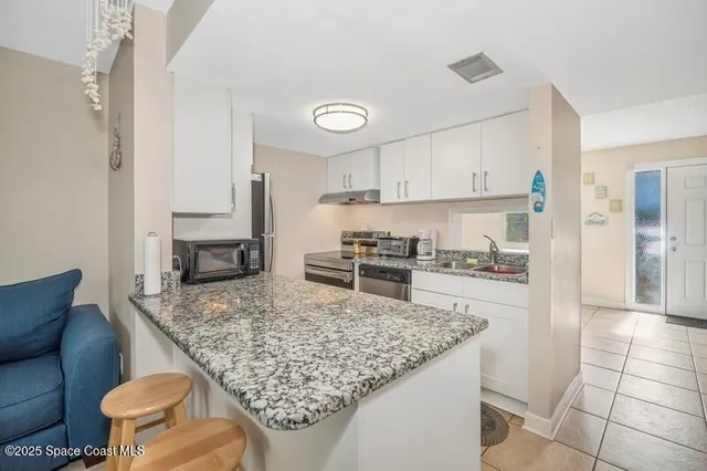 a kitchen with a stove a refrigerator and a sink
