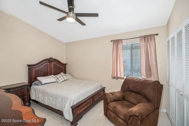 a bedroom with bed couch and window