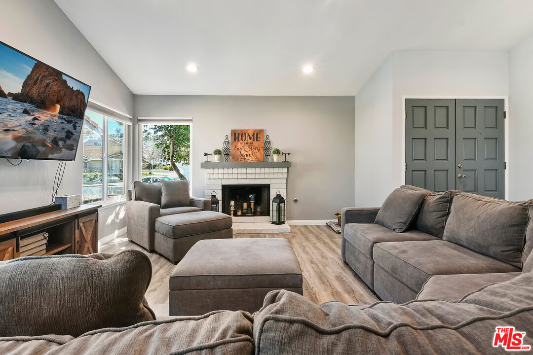 13579 Bear Valley Road Moorpark, CA 93021 - Photo 4 of 25 a living room with furniture large window and a fireplace