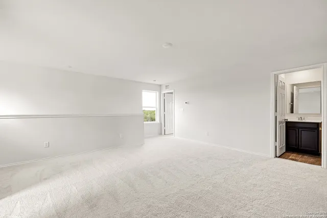 a view of empty room with a fireplace