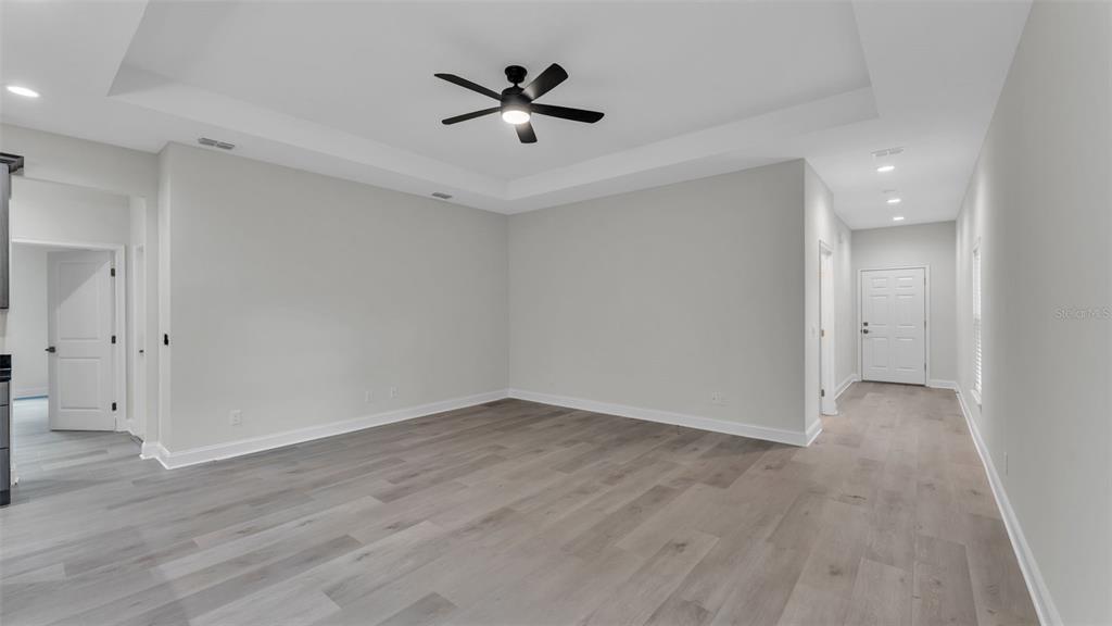 1640 Pearce Road Winter Haven, FL 33881 - Photo 11 of 33 an empty room with wooden floor and ceiling fan