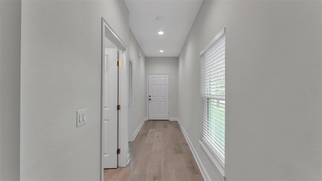 1640 Pearce Road Winter Haven, FL 33881 - Photo 12 of 33 a view of a hallway with wooden floor and a window