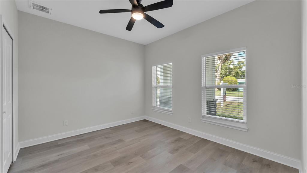 1640 Pearce Road Winter Haven, FL 33881 - Photo 13 of 33 a view of an empty room with wooden floor and a window