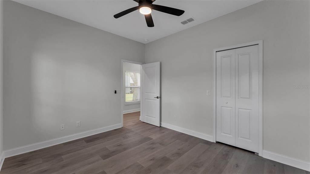 1640 Pearce Road Winter Haven, FL 33881 - Photo 14 of 33 an empty room with wooden floor and windows