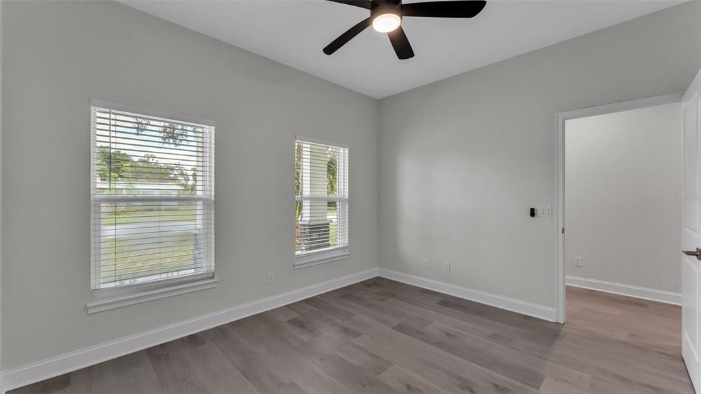 1640 Pearce Road Winter Haven, FL 33881 - Photo 15 of 33 a view of an empty room with wooden floor and a window