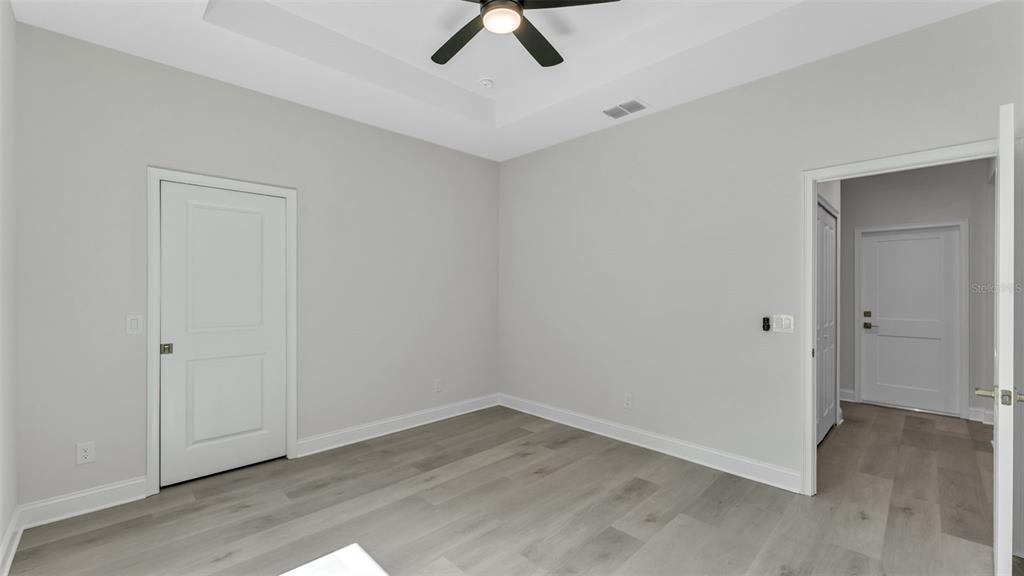 1640 Pearce Road Winter Haven, FL 33881 - Photo 18 of 33 an empty room with a ceiling fan and carpet