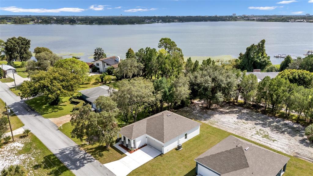 1640 Pearce Road Winter Haven, FL 33881 - Photo 2 of 33 a view of a lake with couches and wooden floor