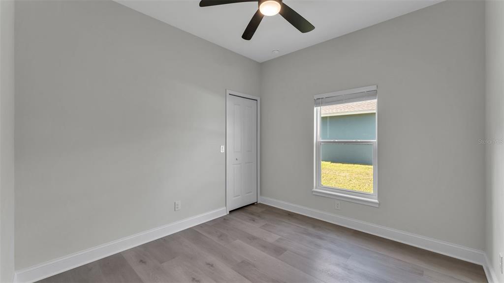 1640 Pearce Road Winter Haven, FL 33881 - Photo 21 of 33 an empty room with a window and ceiling fan