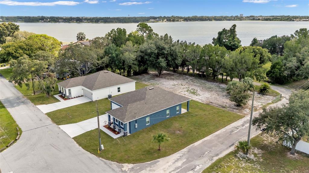 1640 Pearce Road Winter Haven, FL 33881 - Photo 32 of 33 a view of a swimming pool with lake and mountain in the back