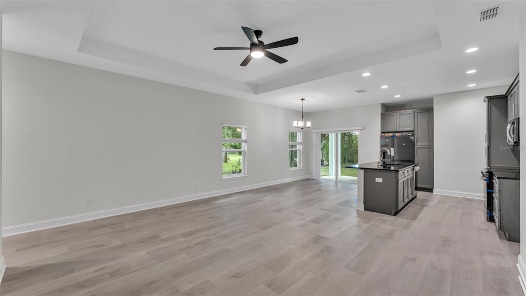 1640 Pearce Road Winter Haven, FL 33881 - Photo 5 of 33 an empty room with windows and a ceiling fan