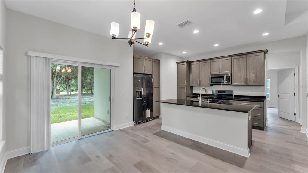 1640 Pearce Road Winter Haven, FL 33881 - Photo 6 of 33 a kitchen with stainless steel appliances granite countertop a refrigerator a stove a sink and a refrigerator