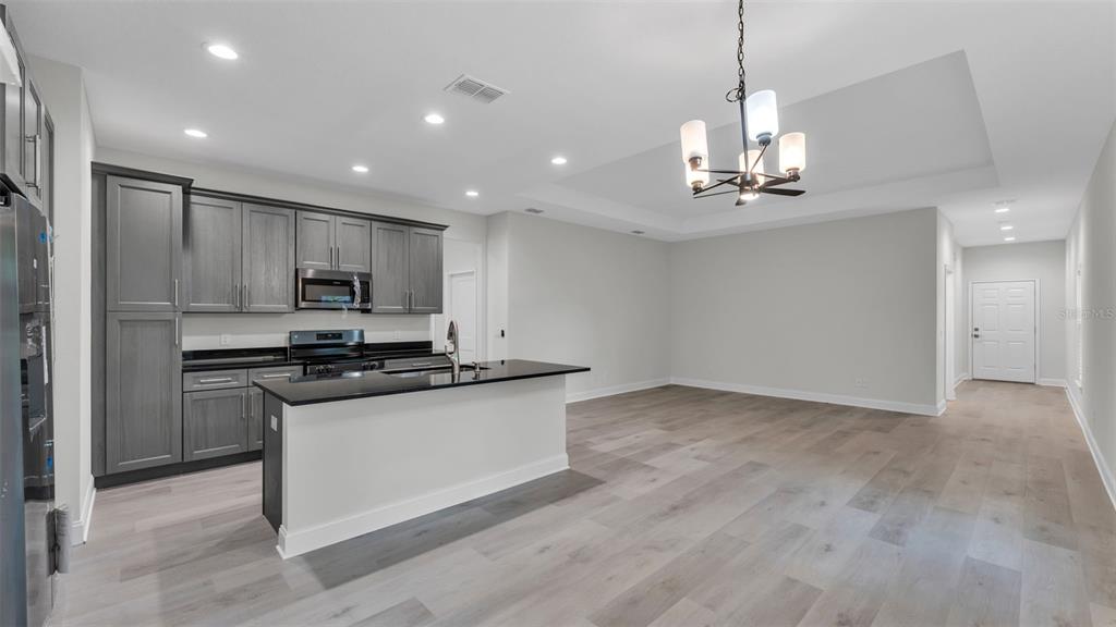 1640 Pearce Road Winter Haven, FL 33881 - Photo 7 of 33 a kitchen with stainless steel appliances a sink a stove a refrigerator and cabinets