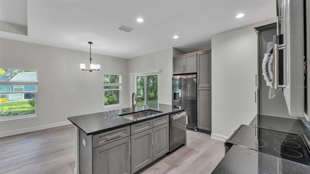 1640 Pearce Road Winter Haven, FL 33881 - Photo 9 of 33 a kitchen with kitchen island a sink appliances and a counter top space