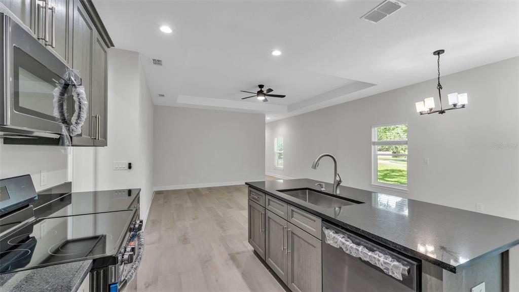 1640 Pearce Road Winter Haven, FL 33881 - Photo 10 of 33 a kitchen with granite countertop a sink cabinets and window
