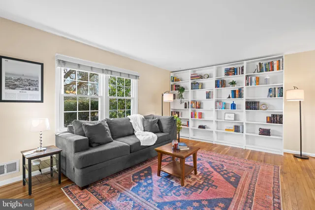 a view of a dining room with furniture a chandelier and wooden floor