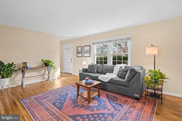 a view of a dining room with furniture a chandelier and wooden floor