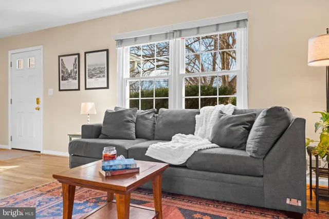 a view of a dining room with furniture a chandelier and wooden floor