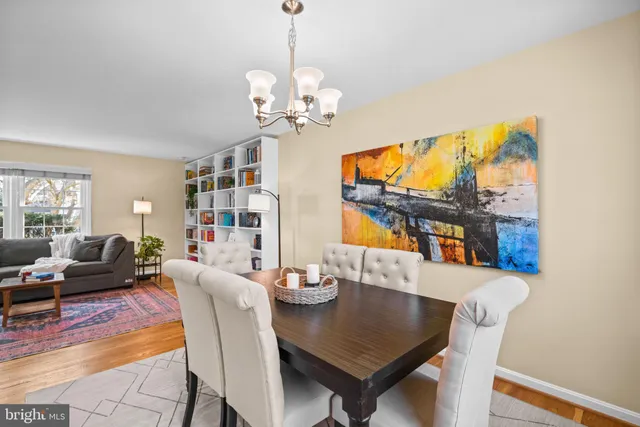 a view of a dining room with furniture a chandelier and wooden floor