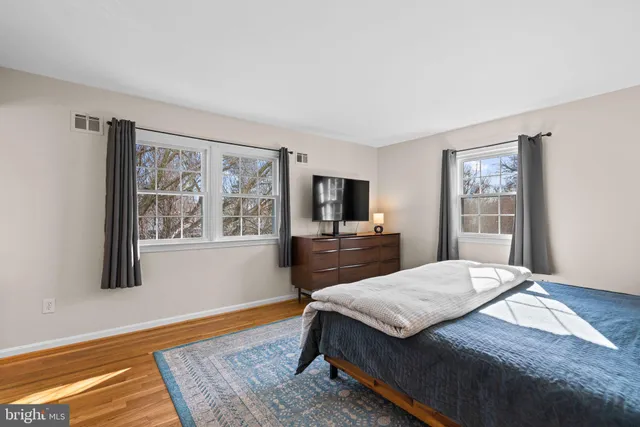 a bathroom with a sink a toilet a mirror and shower