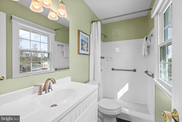 a view of a workspace with a bookshelf and a workspace