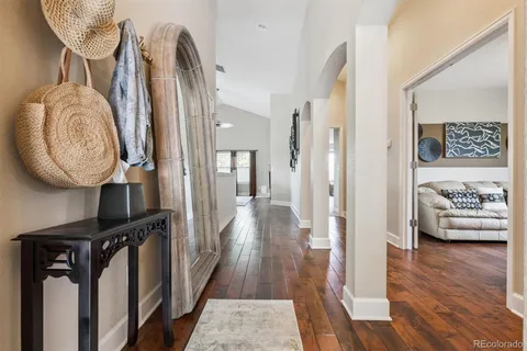 a view of hallway with furniture and wooden floor
