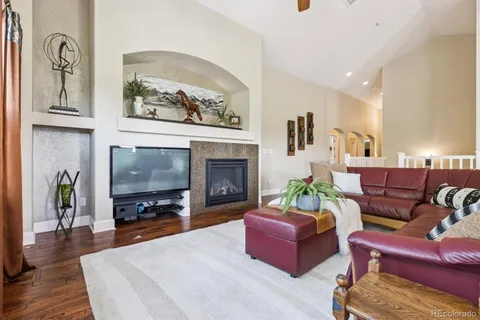 a living room with furniture a flat screen tv and a fireplace
