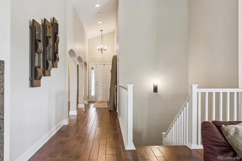 a view of hallway with stairs and wooden floor