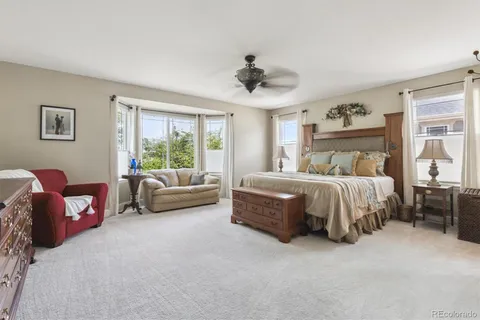 a bedroom with a bed couch and window