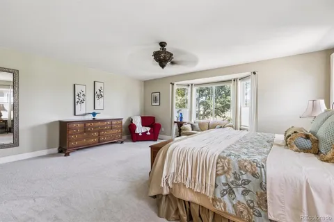 a bedroom with a bed couch and window