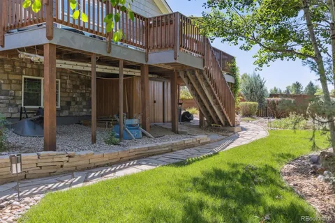 a view of a house with backyard and sitting area