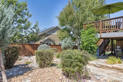a balcony with a potted plants and large tree