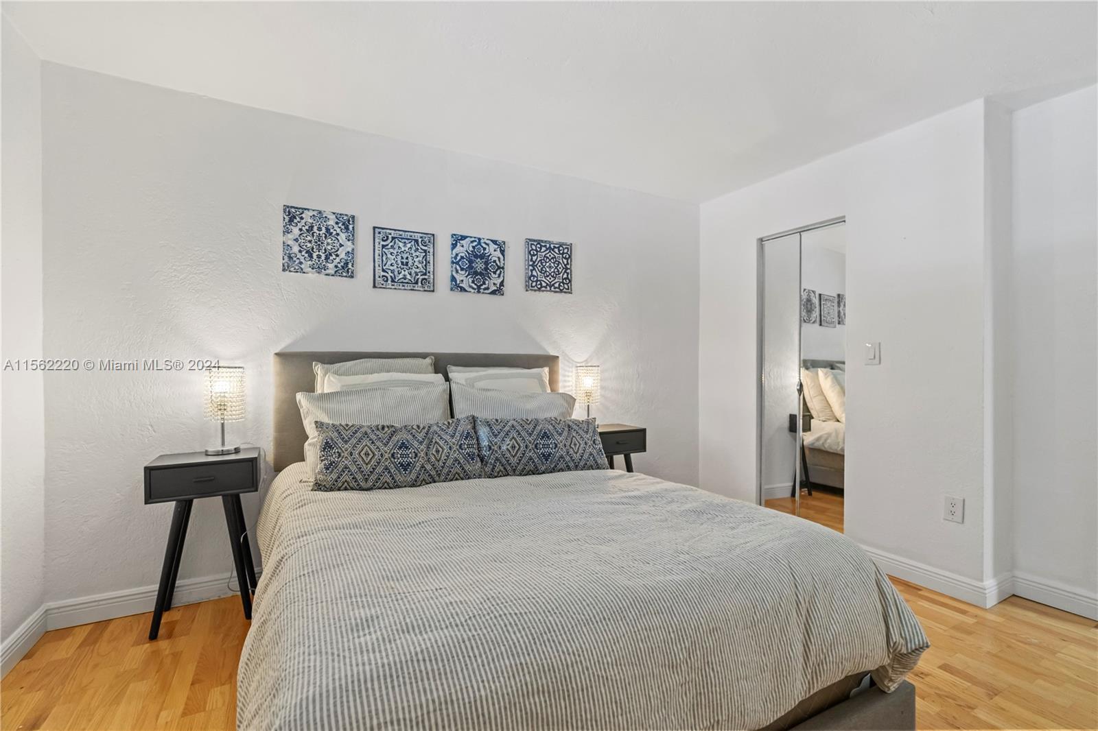 8617 Southwest 68th Court, Unit 24 Pinecrest, FL 33156 - Photo 14 of 22 a bedroom with a bed and a table