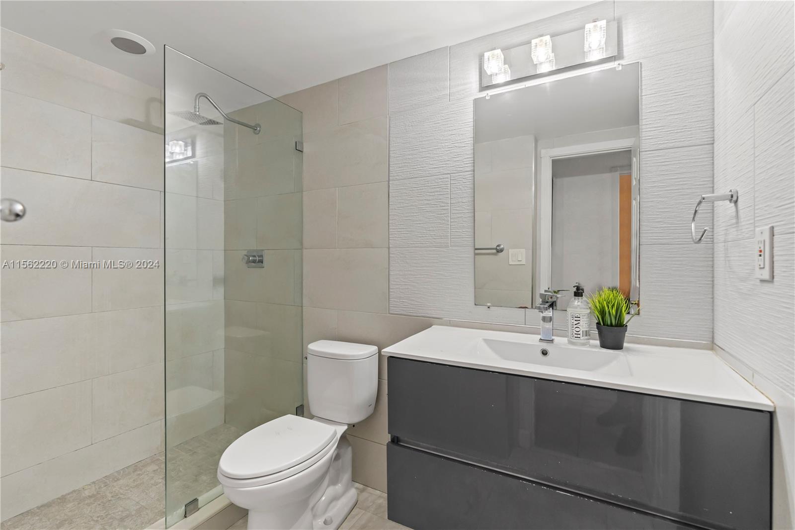 8617 Southwest 68th Court, Unit 24 Pinecrest, FL 33156 - Photo 15 of 22 a bathroom with a sink toilet and shower