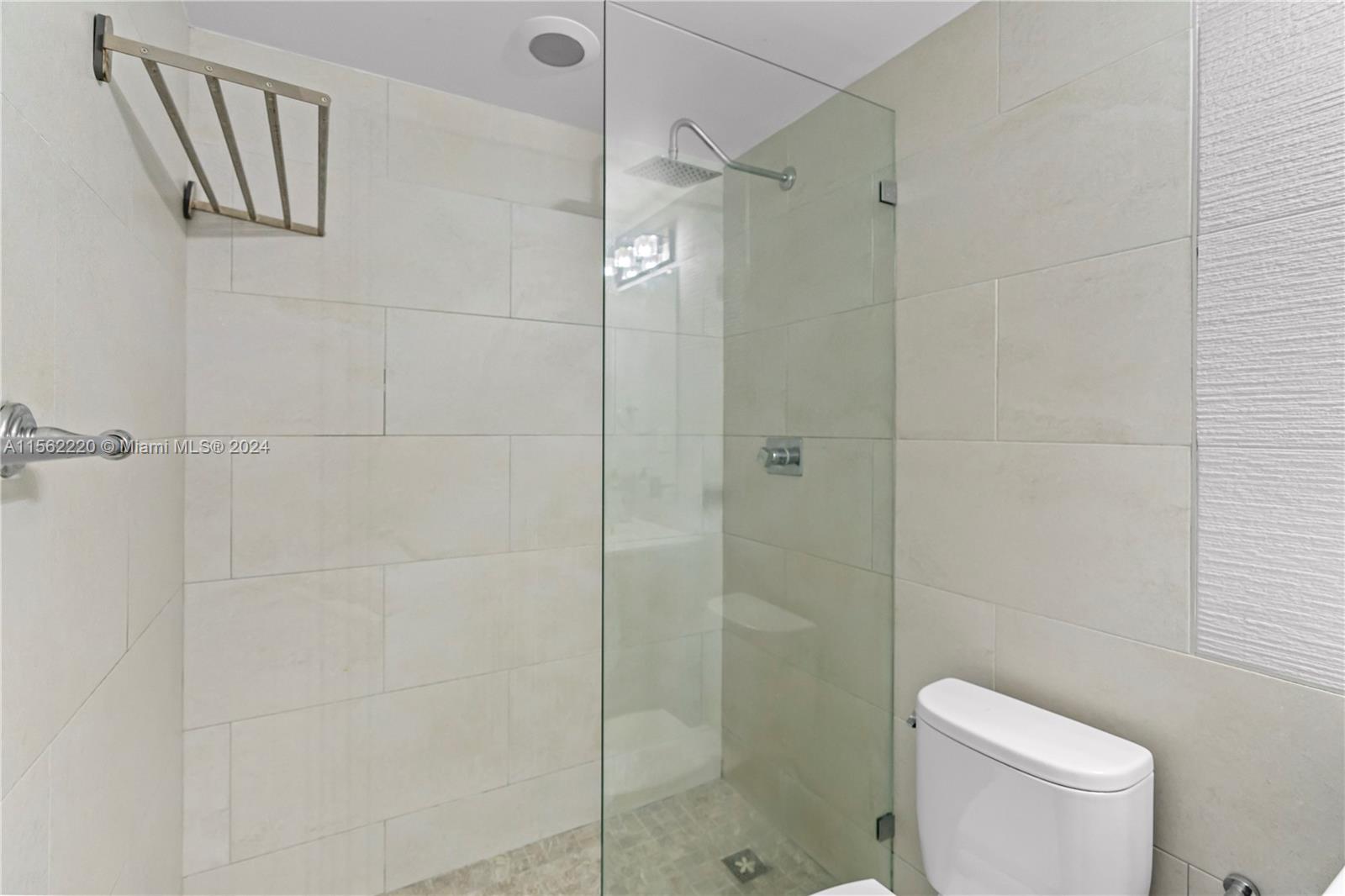 8617 Southwest 68th Court, Unit 24 Pinecrest, FL 33156 - Photo 16 of 22 a bathroom with a shower a toilet and sink