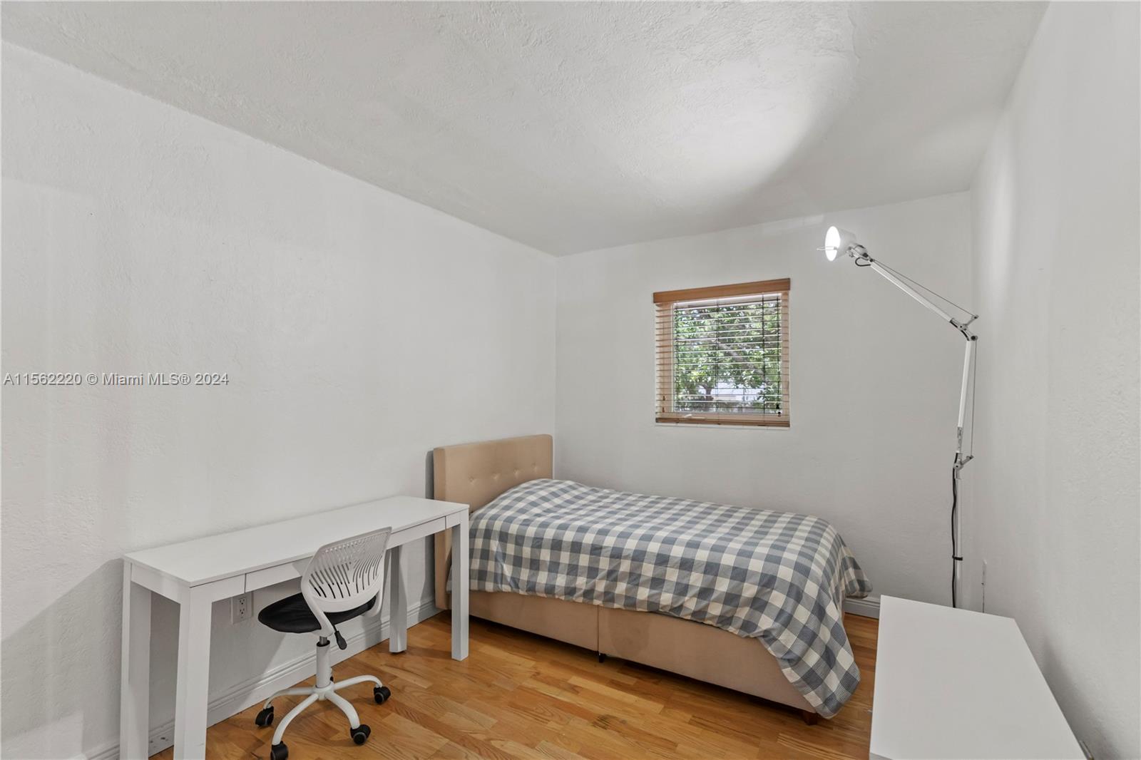 8617 Southwest 68th Court, Unit 24 Pinecrest, FL 33156 - Photo 17 of 22 a bedroom with a bed and a window