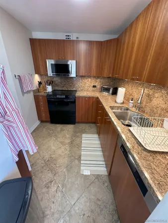 a kitchen with stainless steel appliances granite countertop a sink stove and oven