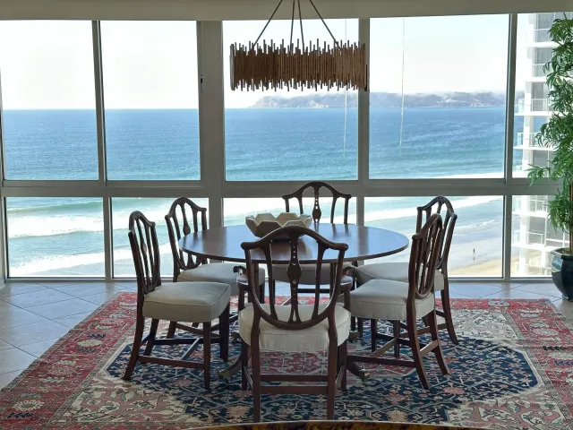 a view of a chairs and table in the balcony